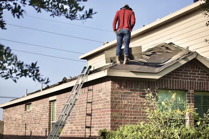 Professional roofer working on a residential roof in Fargo